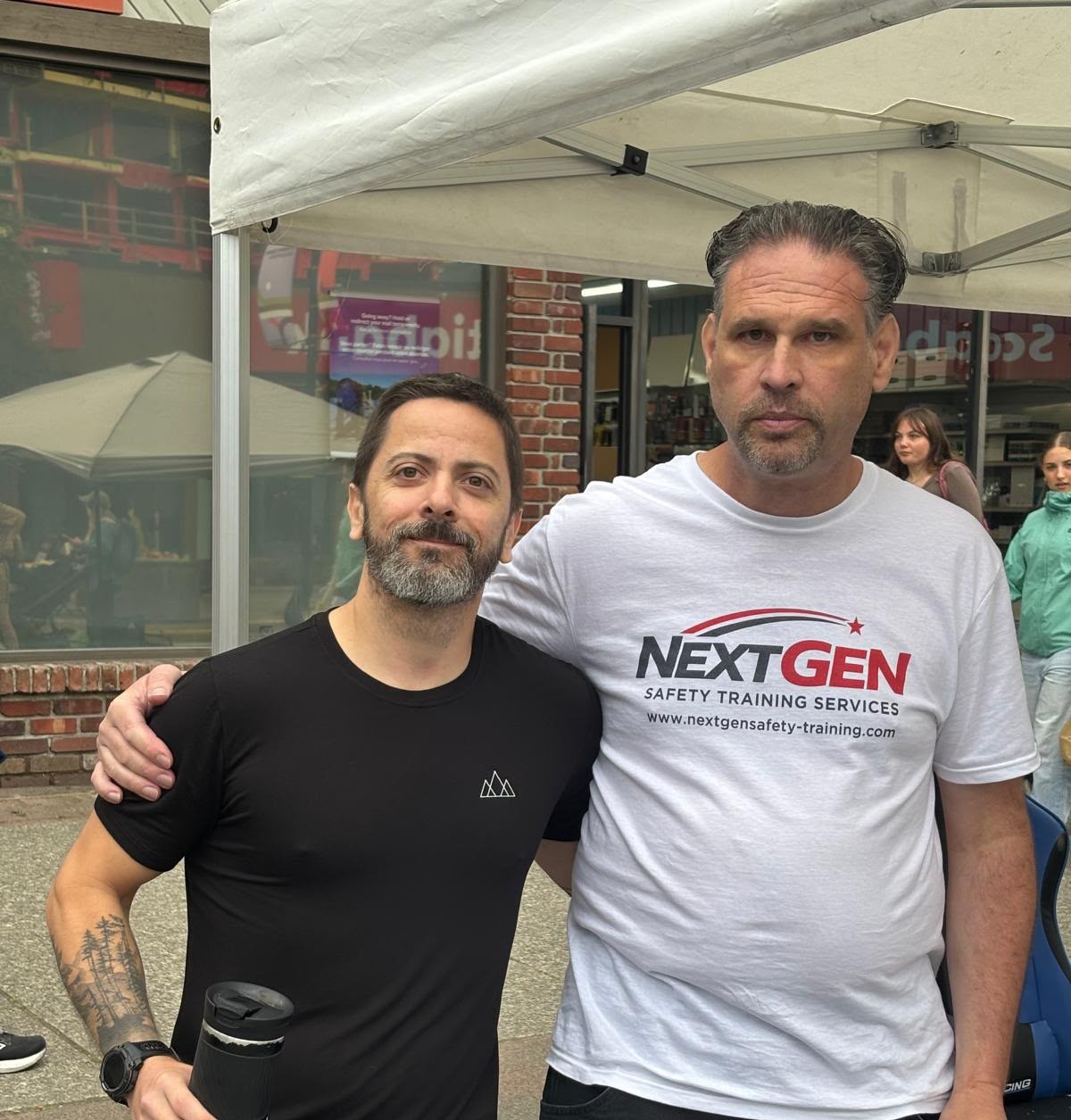 Bruno Gazire of Aris Development with a NextGen Safety Training Services partner at a Squamish community event